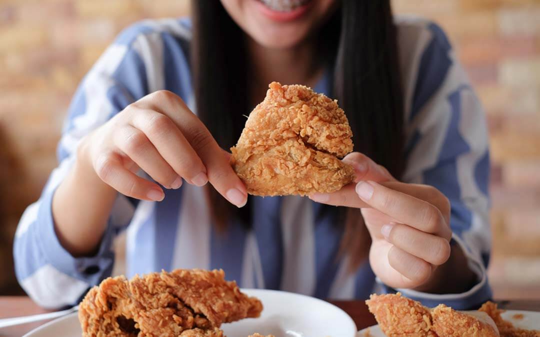 Woman holding fried chicken