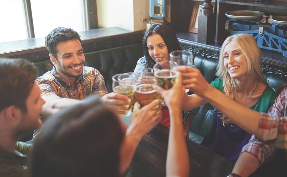 Group of people clinking beer glasses