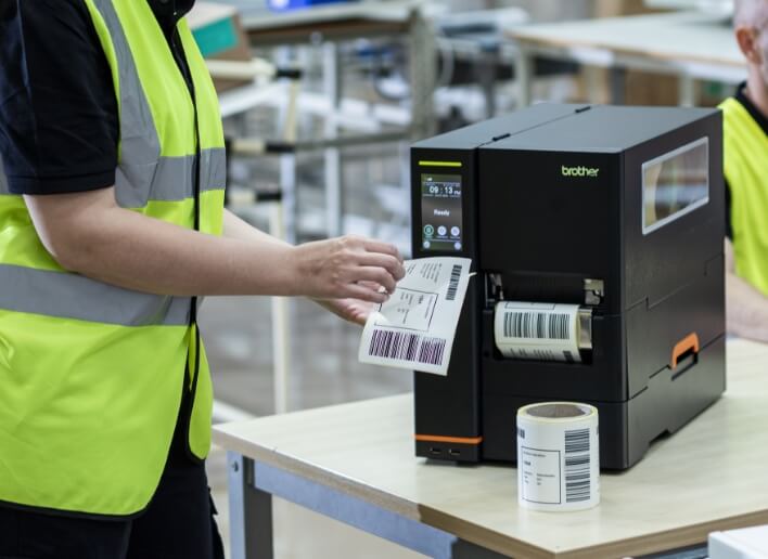 Employee Peeling Labels from Brother Titan Industrial Printer