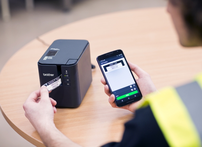 Female Warehouse Worker Printing Asset Tag from P-touch Desktop Printer