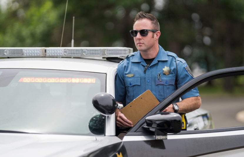 Police officer outside police car