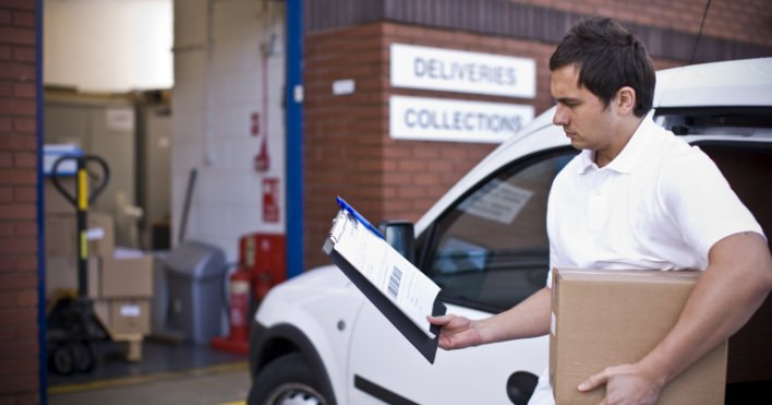 Route driver looking at clipboard