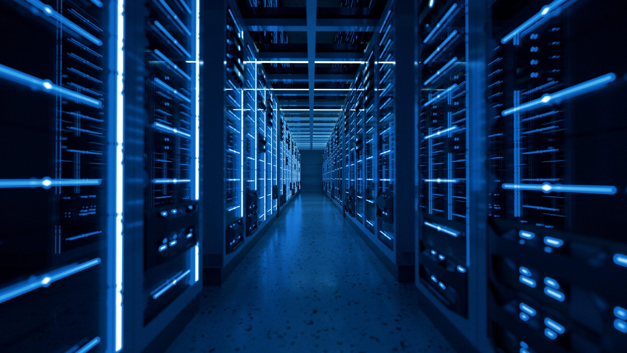 A hallway of server racks glows with blue LED lights in a modern data center, reflecting the latest labeling standards designed to meet growing AI demands.